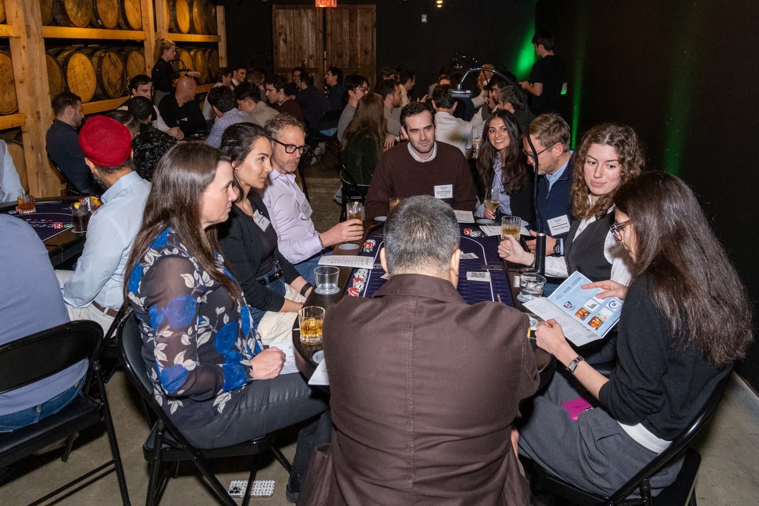 A full room of guests playing at a Full House Vision corporate poker night